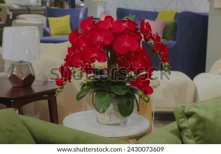 Fake orchid flowers are blushing red for table decoration