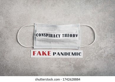 Fake Pandemic. Conspiracy Theory. The Inscription On A Light Gray Background And A Medical Mask. Fake News During Corona Virus / COVID-19 