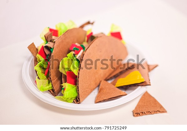 Fake tacos\
made of cardboard, fast food, junk\
food.
