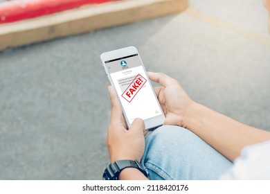 Fake Text Message SMS Scam Or Phishing Concept. Man Hands Using Smart Phone