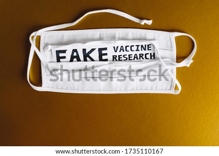 Fake vaccine research. Text on a white medical mask on a beautiful gold background. Coronavirus. Vaccination and exacerbation. Biohazard. Vaccine. Deception, Scam. Fake 2019-ncov
