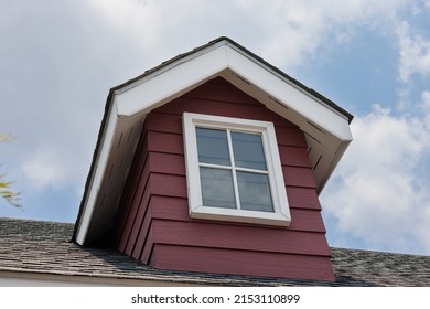 fake window on garret house and roof shingle with a rain cloud on blue sky background. Asphalt Shingles or Bitumen Tiles. blue sky background. Asphalt Shingles or Bitumen Tiles. 