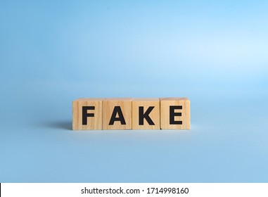 FAKE word with building blocks on a blue background