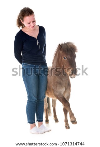 Falabella miniature horse and girl in front of white background