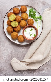 Falafel Balls With Yogurt Sauce In A Plate On A Brown Rustic Background. Top View, Flat Lay