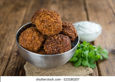 Falafel (close-up shot; selective focus) on an old wooden table