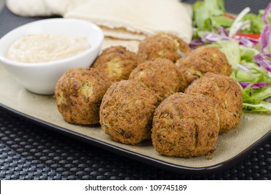 Falafel - Deep Fried Chickpeas Balls Served With Tahini, Salad And Pitta Bread.