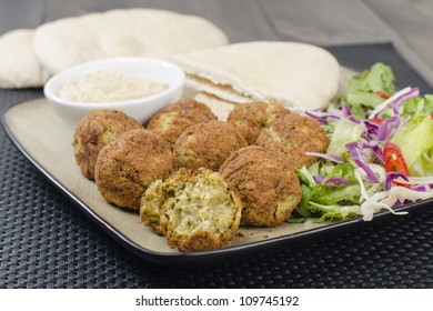 Falafel - Deep Fried Chickpeas Balls Served With Tahini, Salad And Pitta Bread.