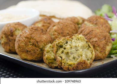 Falafel - Deep Fried Chickpeas Balls Served With Tahini, Salad And Pitta Bread.