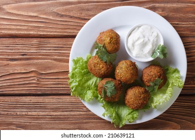 Falafel On A White Plate With Sauce Tzatziki Close-up View From Above Horizontal  