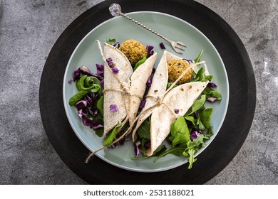 Falafel wrap with fresh veggies and sauce - Powered by Shutterstock