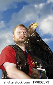 Falconer and bald eagle, low angle view