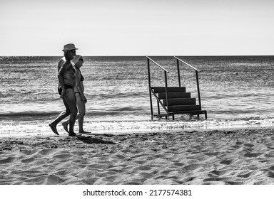 FALIRAKI, GREECE - JUN 30, 2022: Senior Couple Walking On Sandy Beach