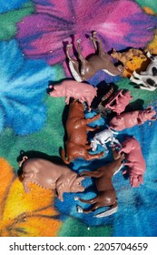 Falkenberg, Sweden - July 30 2022: Plastic Toy Animals On A Colorful Blanket.