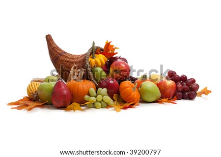 A Fall arrangement in a cornucopia on a white background