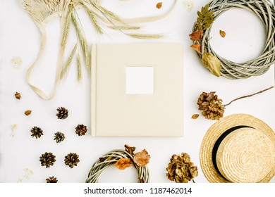 Fall Autumn Composition With Wedding Or Family Photo Album, Wreath Frame, String Bad, Rye Ears, Cones, Dry Leaves On White Background. Flat Lay, Top View Mock Up.