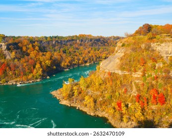 Fall background. Landscape during day light. Autumn trees on the river bank. Mountains and forest. Vivid colours in the forest. Banff National Park, Alberta, Canada. 
