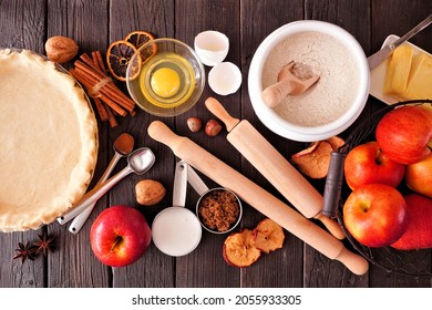 Fall Baking Table Scene With Apple Pie Ingredients. Top Down View Over A Dark Wood Background.