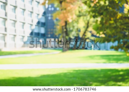 Fall blurred background with build. Buildings, windows, trees, study. A part of white buildings with windows, trees and gazon. Place for your text.