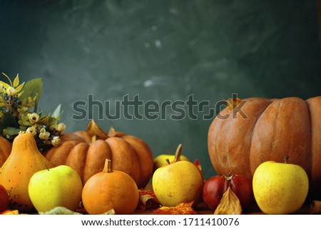 Fall Colored Pumpkins and apples On Wooden desk.