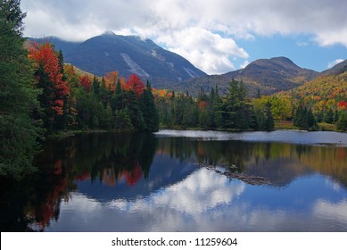 Fall colors of the Adirondacks reflected in a lake.