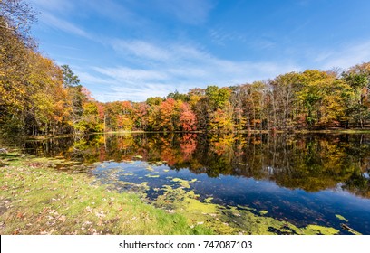 Fall Colors On A Pond In The Poconos Of Pennsylvania.