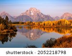 Fall colors on snake river with reflection of Mt Moran, Grand Teton, Wyoming 