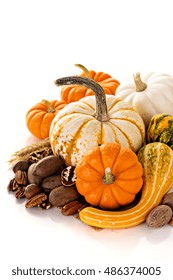 Fall copyspace with decorative pumpkins, nuts and corn isolated on white