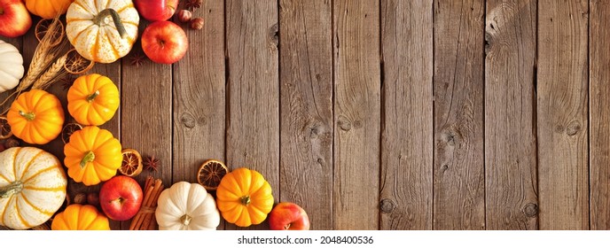 Fall Corner Border Of Pumpkins, Apples And Spices. Top View On A Rustic Dark Wood Background With Copy Space.