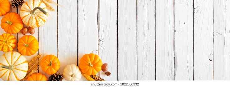 Fall Corner Border Of Pumpkins And Autumn Decor. Top Down View On A Rustic White Wood Banner Background With Copy Space.