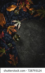 Fall Dark Stone Background With Autumn Red And Yellow Leaves Warm Sweater Or Blanket And Little Pumpkins,  Top View Copy Space