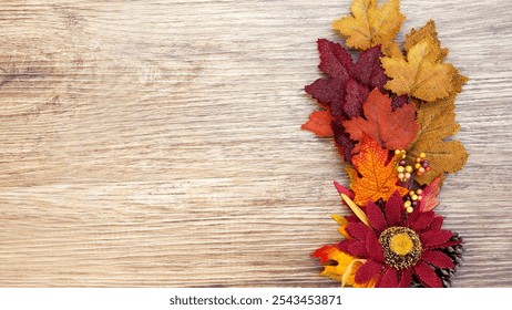 Fall decor, wooden surface, red, orange, gold leaves, sparkly effect, glittery autumn leaves, red flower, pinecone, light beige wood grain, upper-right arrangement, seasonal - Powered by Shutterstock