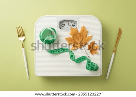 Fall fitness journey: Top view featuring scale, tape measure, cutlery, maple leaves on green surface. Image perfect for promotions or advertisements