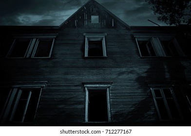 The Fall Of The House Of Usher. Old Abandoned House In The Night With Menacing Sky.