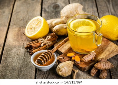 Fall Immune System Booster - Ginger And Turmeric Tea And Ingredients, Rustic Wood Background