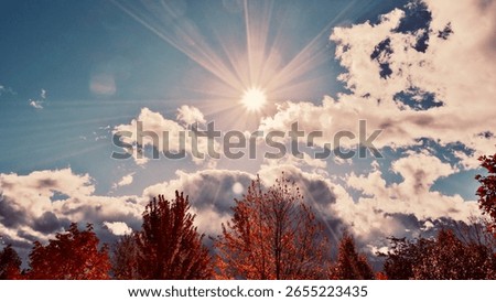Fall landscape with sunburst and clouds