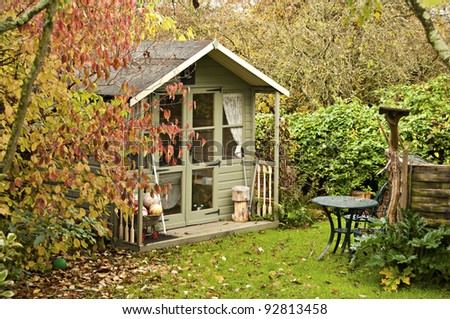 Fall leaves surround the summerhouse at the bottom of the garden