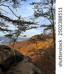 Fall Leaves At The Top Of Sunset Rock On Lookout Mountain In Chattanooga Tennessee. The Sun Is Setting And Shining Light On The Face Of The Mountain. There Is A River In The Background.