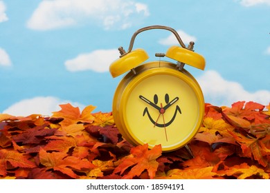 Fall Leaves With Yellow Clock On Sky Background, Fall Back Time Change