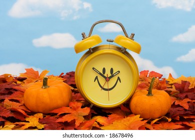 Fall Leaves With Yellow Clock And Pumpkins On Sky Background, Fall Back Time Change