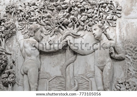 The Fall of Man  (Eden narrative) - Adam and Eve  take fruits from a  Tree of life  in  Garden of Eden - relief on an external facade of  Cathedral  Orvieto (Duomo),  Umbria, Italy