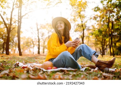 Fall Picnic With Pumpkin. Stylish Woman Enjoying Autumn Weather In The Park. People, Lifestyle, Relaxation And Vacations Concept. Autumn Harvest.