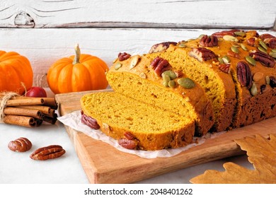 Fall Pumpkin Bread. Slices Close Up Against A White Table Scene Background.