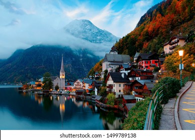 Fall scenery of Hallstatt at dawn, a peaceful lakeside village & a UNESCO heritage site in Salzkammergut region of Austria, with beautiful reflections in lake water & majestic mountains in background