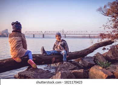 Fall Season, Hello Autumn. Cute Siblings, Sister And Brother, Walking Together In Forest On The Bank Of River, Golden Trees And Golden Light, Social Distance, Family Weekend, Beautiful Nature Outside