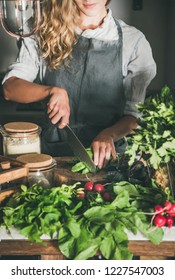 Fall Seasonal Vegetarian, Vegan Dinner Cooking. Woman In Linen Apron Cutting Green Vegetable Ingredients On Concrete Kitchen Counter. Slow Food, Comfort Food, Healthy Diet, Clean Eating