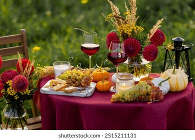 Fall sunset, romantic date outdoors in meadow, marriage proposal. Romantic candlelit dinner in the field. Table honeymoon set for two with luxurious food, glasses of red wine in a restaurant.  - Powered by Shutterstock