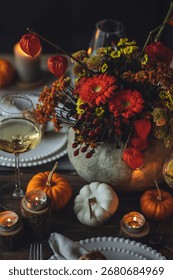 Fall table decoration with pumpkins, wine. Family cozy thanksgiving dinner arrangement indoors at home, wedding elegant decor. Countryside style, simple handmade setting, autumn mood, inspiration.