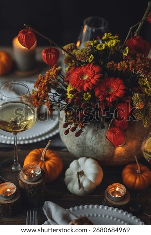 Fall table decoration with pumpkins, wine. Family cozy thanksgiving dinner arrangement indoors at home, wedding elegant decor. Countryside style, simple handmade setting, autumn mood, inspiration.