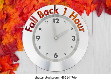 Fall Time Change, Some Fall Leaves And A Clock On Weathered Wood With Text Fall Back 1 Hour